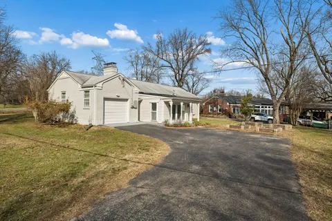 a front view of a building with a yard