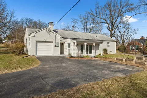 a view of a house with a yard and garage