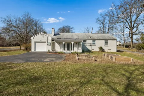 a front view of a building with a yard