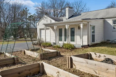 a view of a house with backyard tub and sitting area