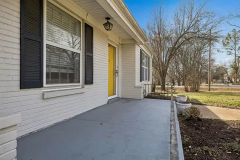 a view of a house with a large tree