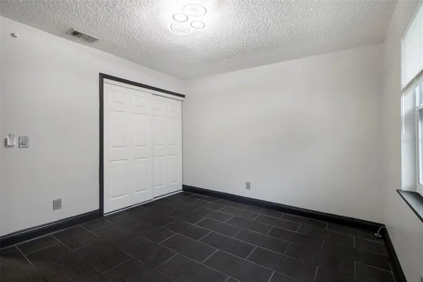 a view of a balcony with wooden floor and iron fence
