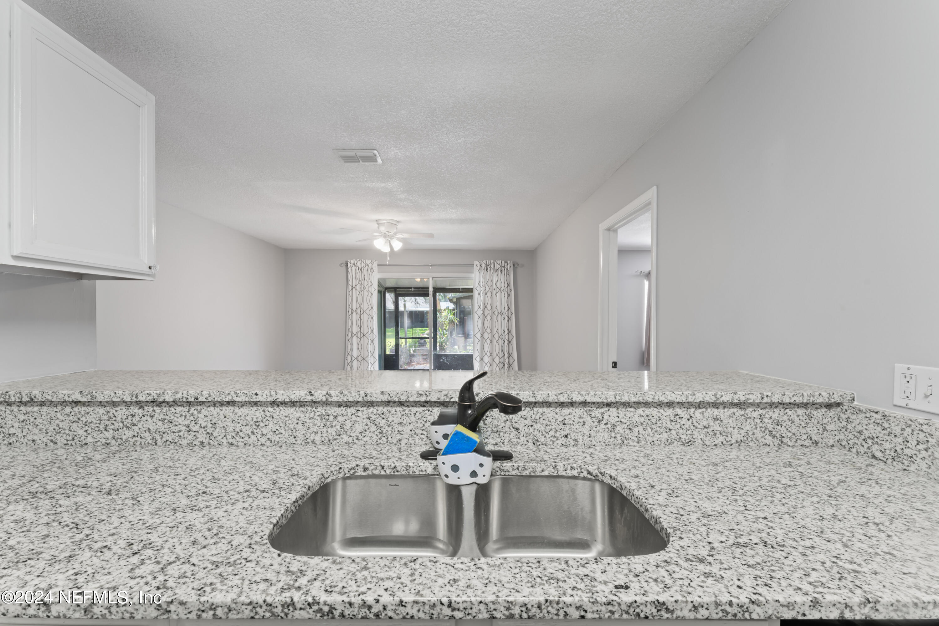 1283 The Grove Road Orange Park, FL 32073 - Photo 11 of 49 a kitchen with granite countertop a sink and a granite counter tops