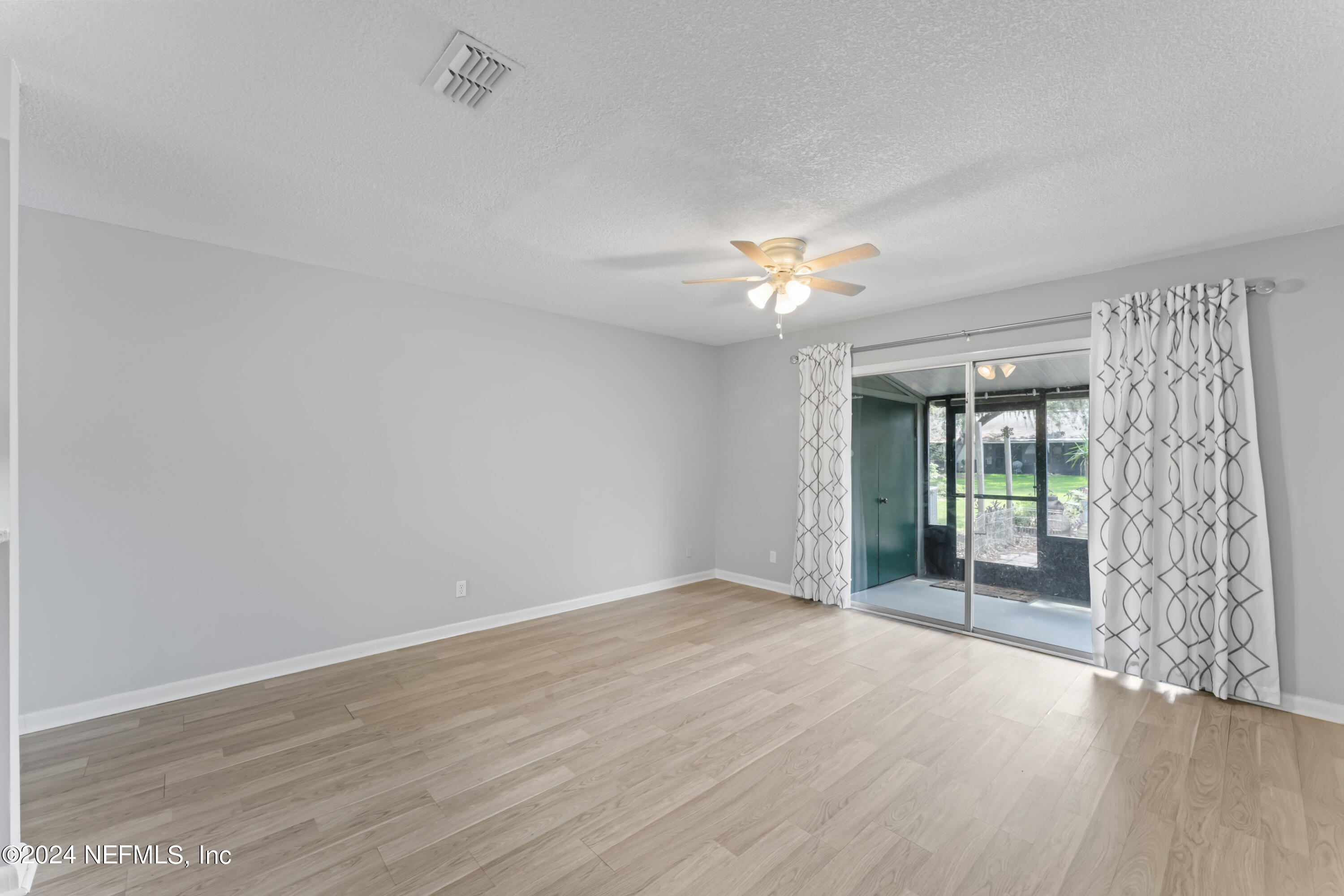 1283 The Grove Road Orange Park, FL 32073 - Photo 14 of 49 wooden floor in an empty room with a window