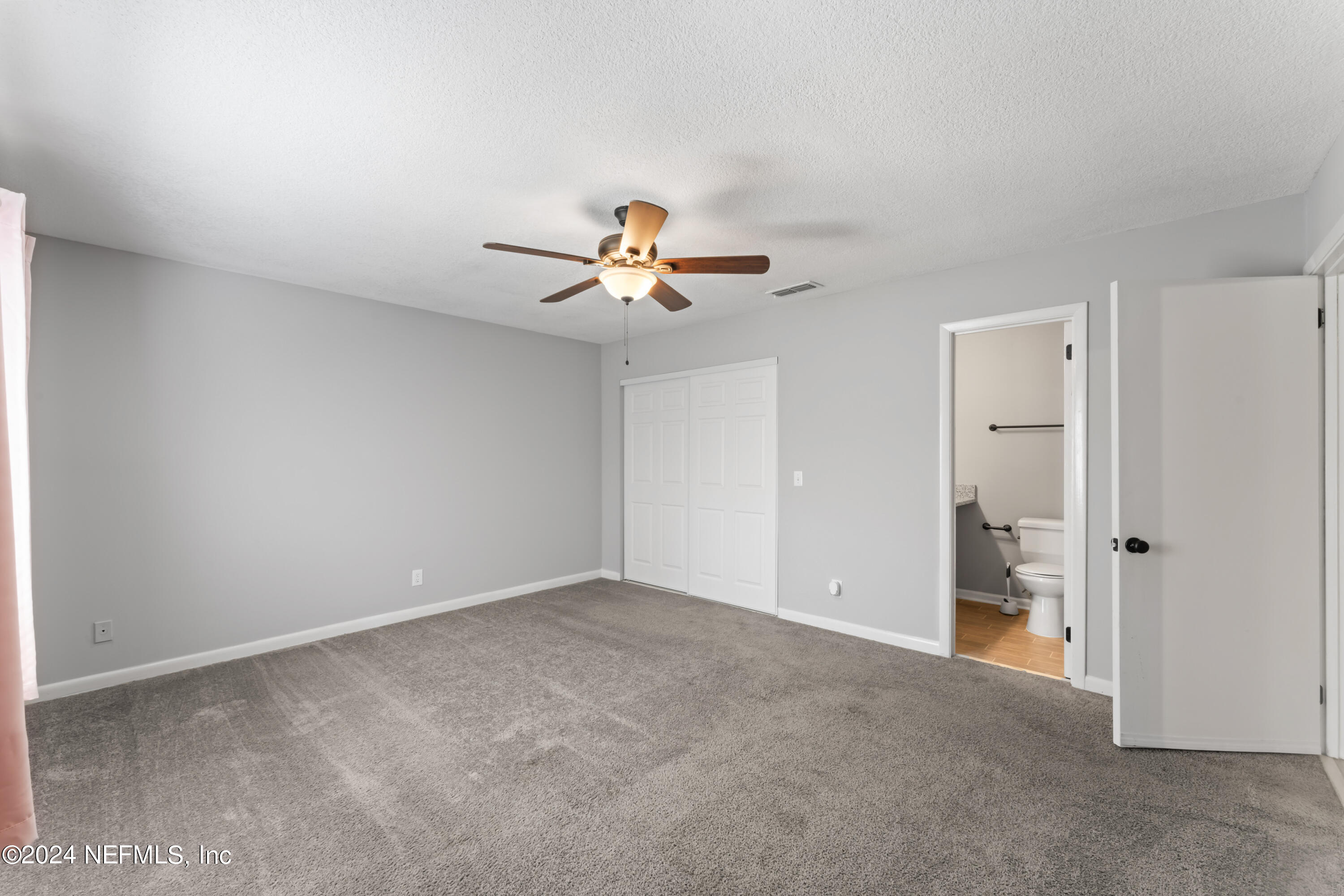 1283 The Grove Road Orange Park, FL 32073 - Photo 17 of 49 wooden floor in an empty room with a window