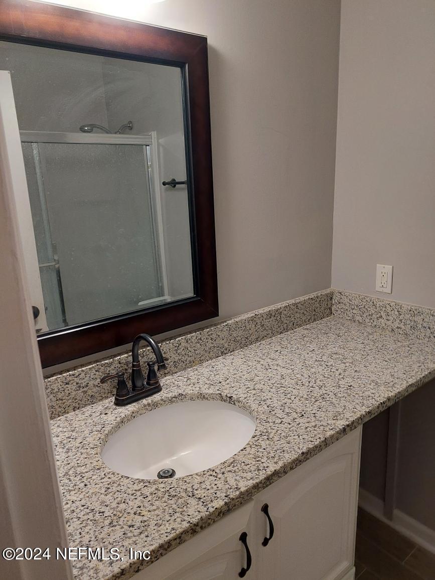 1283 The Grove Road Orange Park, FL 32073 - Photo 20 of 49 a bathroom with a granite countertop sink and a mirror