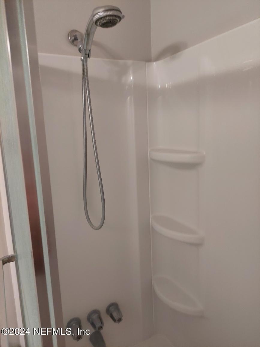 1283 The Grove Road Orange Park, FL 32073 - Photo 21 of 49 a bathroom with a glass shower door