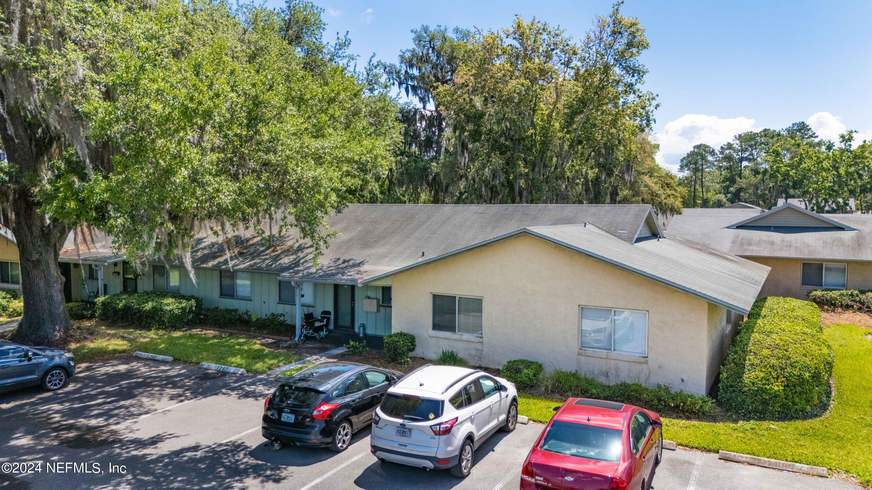1283 The Grove Road Orange Park, FL 32073 - Photo 37 of 49 a front view of a house with a garden and trees