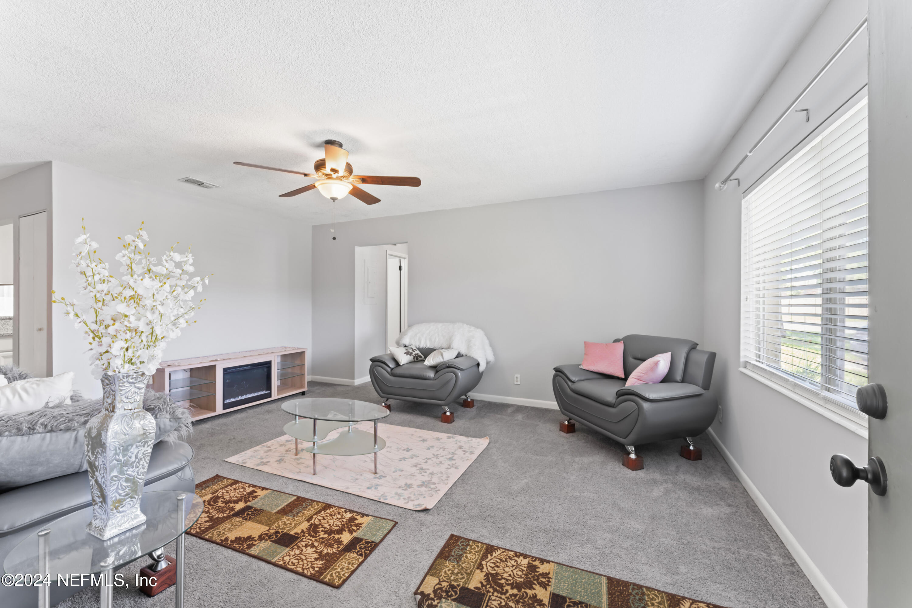 1283 The Grove Road Orange Park, FL 32073 - Photo 5 of 49 a living room with furniture a fireplace and a chandelier