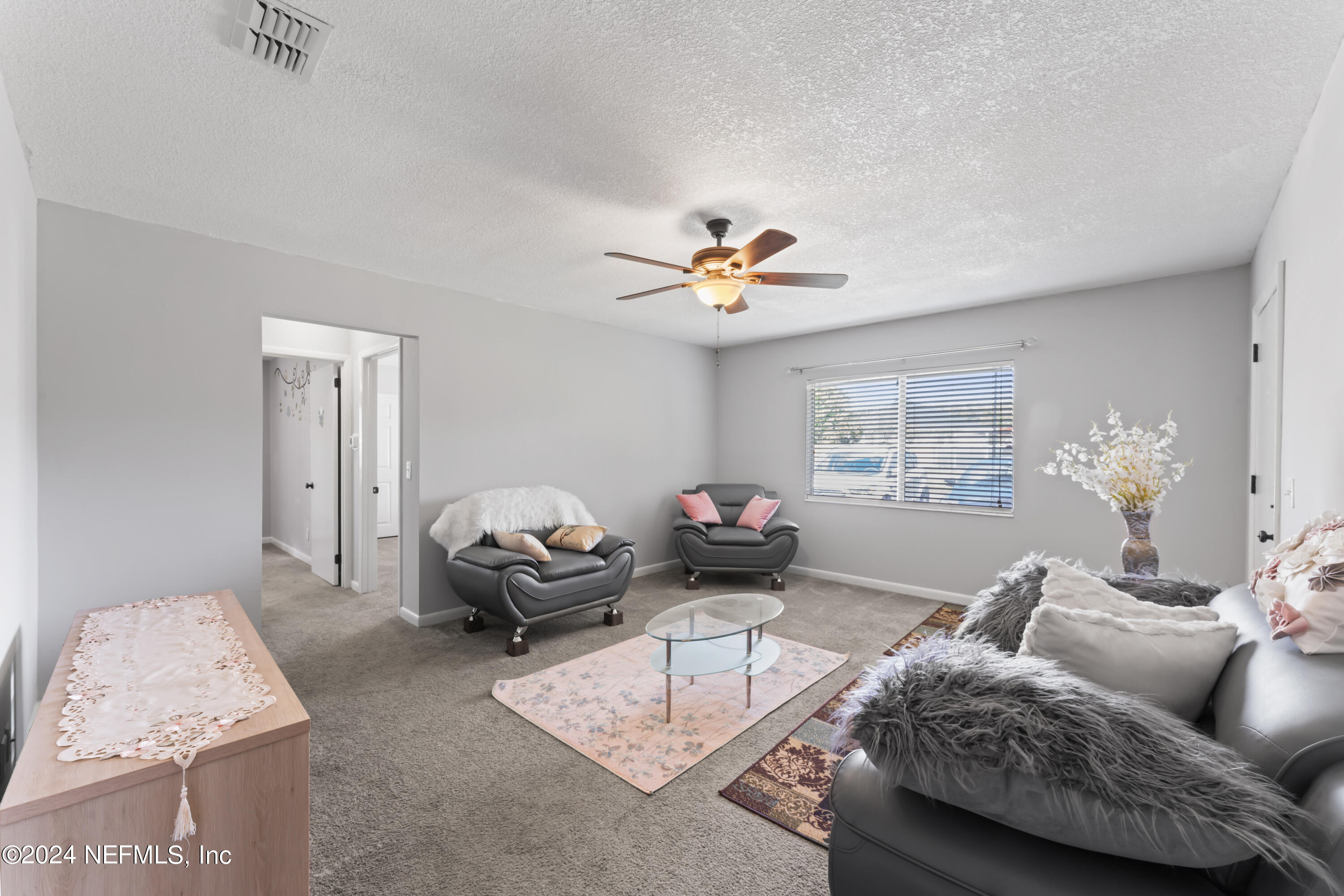 1283 The Grove Road Orange Park, FL 32073 - Photo 8 of 49 a living room with furniture and a chandelier