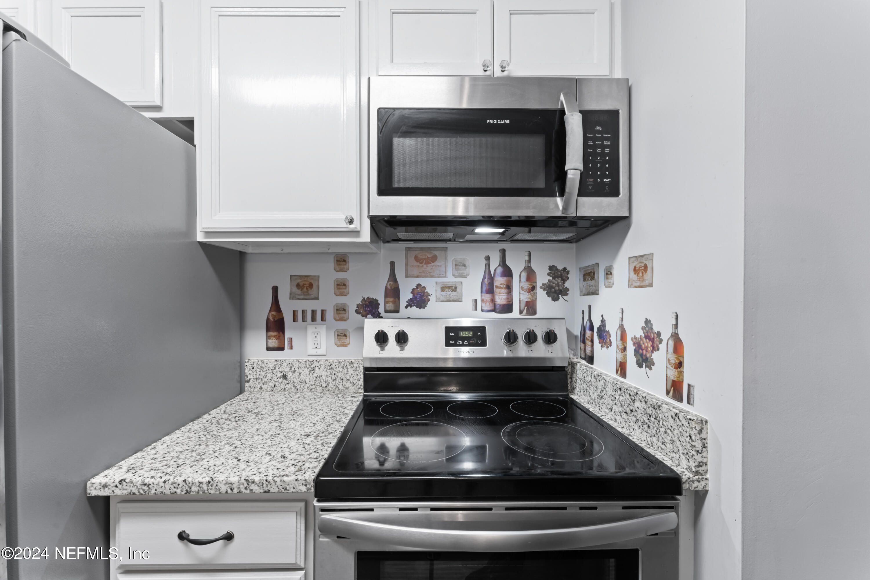 1283 The Grove Road Orange Park, FL 32073 - Photo 10 of 49 a kitchen with a stove and a microwave