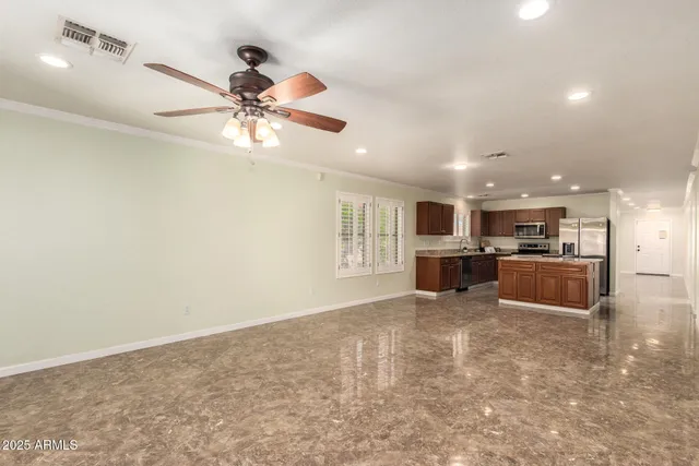 a kitchen with a sink a refrigerator and wooden floor