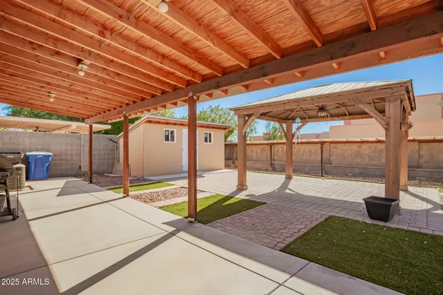 a view of a house with backyard and sitting area