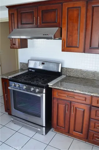 a stove top oven sitting inside of a kitchen