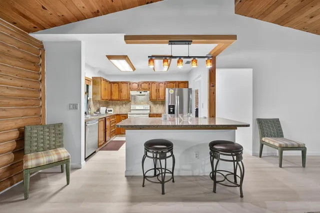 a kitchen with a table and chairs in it