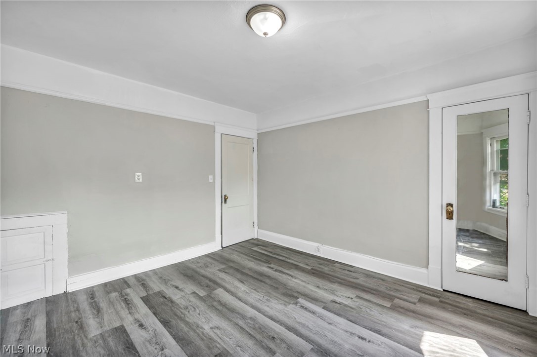 1659 Lee Road Cleveland, OH 44118 - Photo 32 of 46 Light gray wall paint, wood-finish flooring, white trim, recessed door, and a flush-mount ceiling light