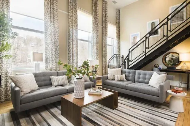 a living room with furniture and a large window