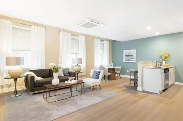 a living room with furniture and large windows