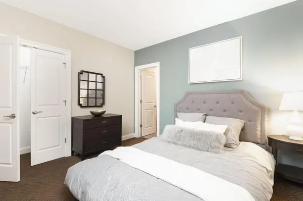 a bedroom with a bed and window