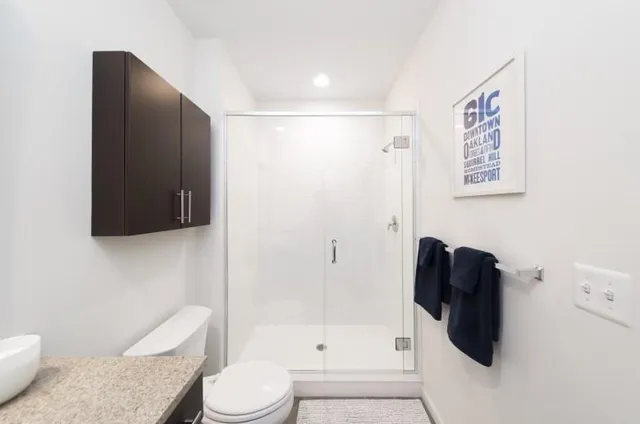 a bathroom with a toilet and a shower