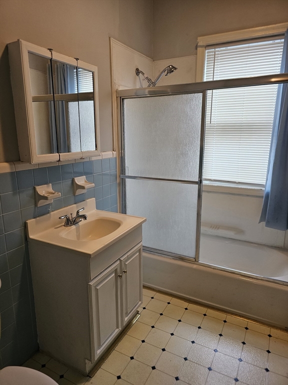 404 Stevens Street, Unit 2 Lowell, MA 01851 - Photo 10 of 12 a bathroom with a sink toilet and shower