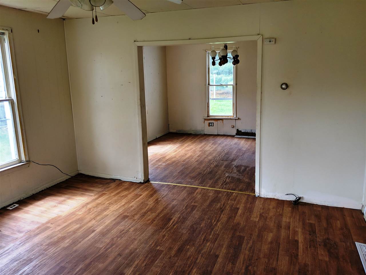 310 South Ridge Street Shannon, IL 61078 - Photo 3 of 15 an empty room with wooden floor and windows
