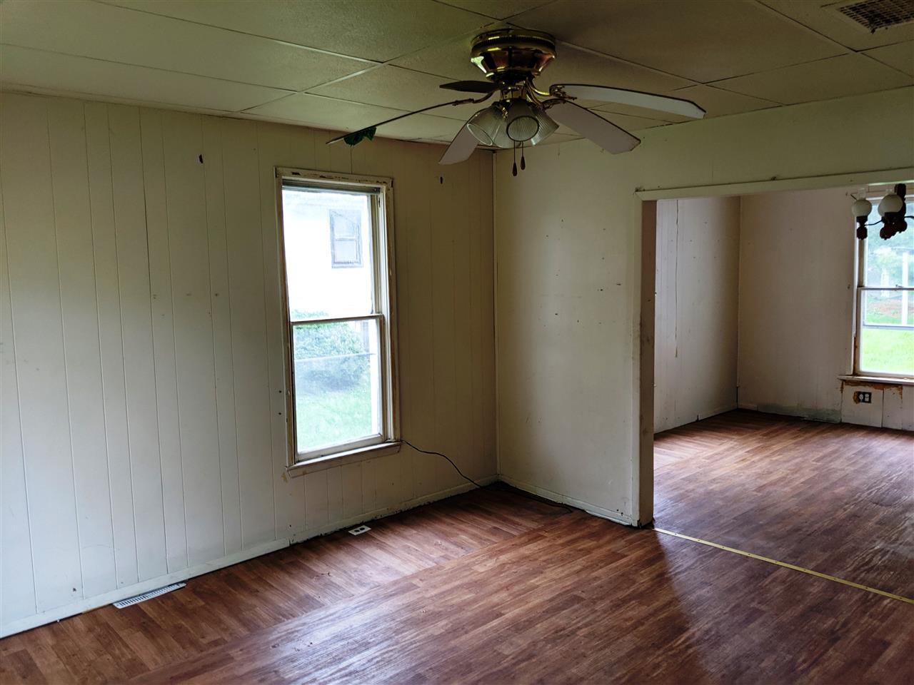 310 South Ridge Street Shannon, IL 61078 - Photo 4 of 15 an empty room with wooden floor fan and windows