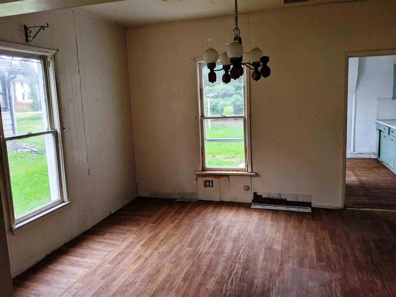 310 South Ridge Street Shannon, IL 61078 - Photo 5 of 15 an empty room with wooden floor and windows