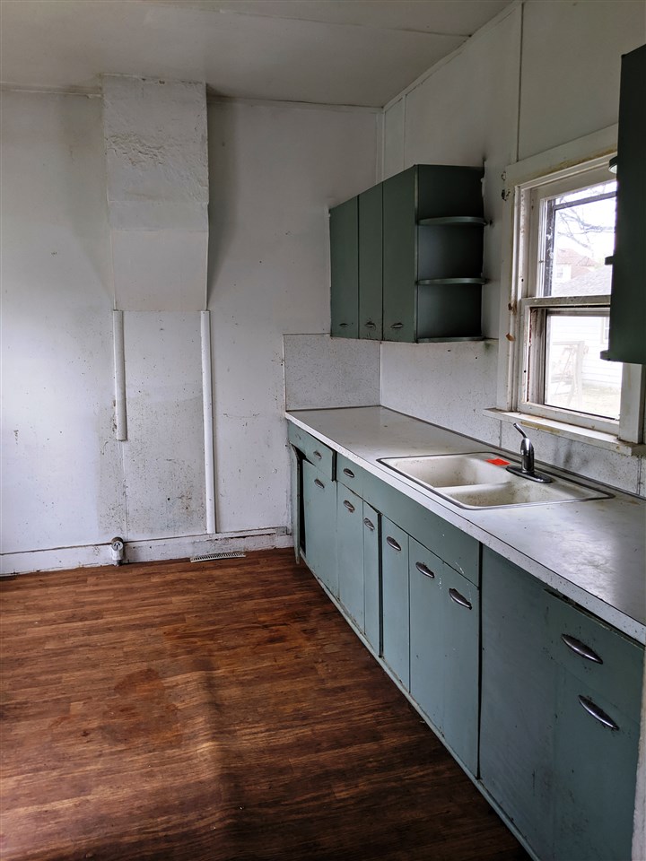 310 South Ridge Street Shannon, IL 61078 - Photo 7 of 15 a kitchen with stainless steel appliances granite countertop a sink a stove and a microwave oven