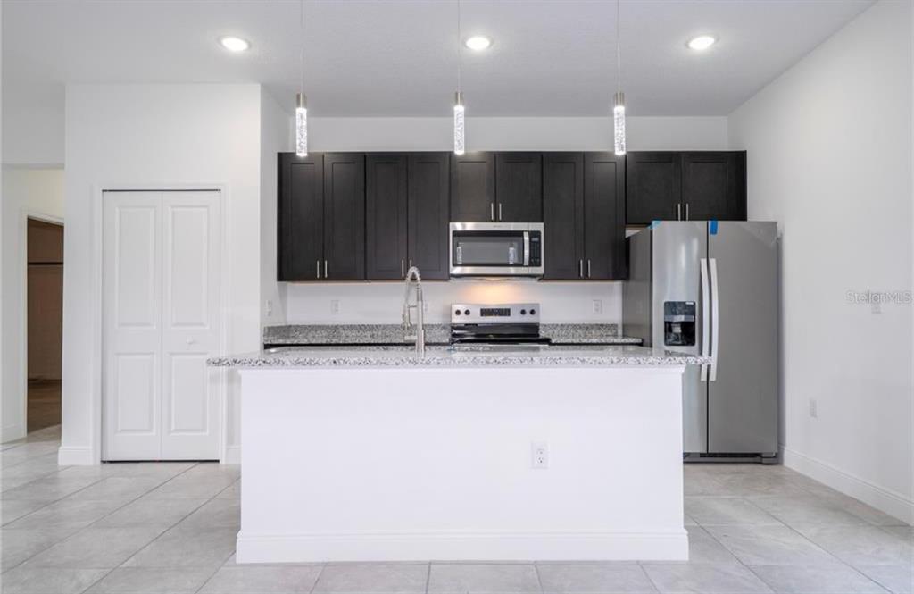 9809 North Swanee Terrace Citrus Springs, FL 34433 - Photo 11 of 46 a kitchen with stainless steel appliances a refrigerator a stove a sink and a oven