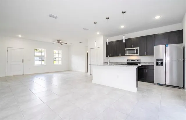 a view of kitchen with refrigerator and microwave