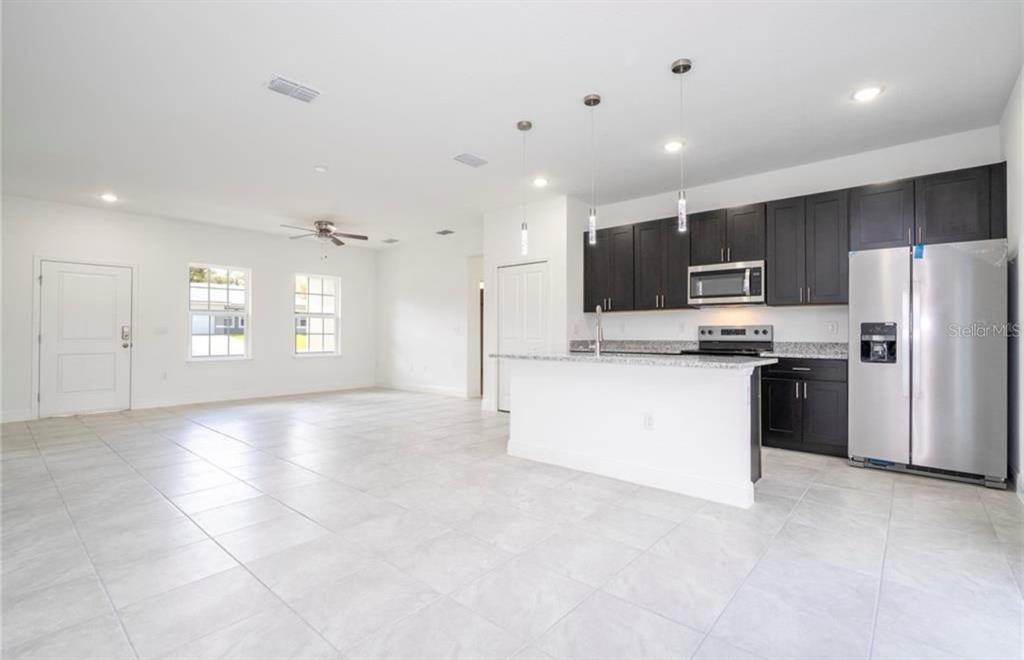 9809 North Swanee Terrace Citrus Springs, FL 34433 - Photo 13 of 46 a view of kitchen with refrigerator and microwave