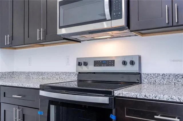 a stove top oven sitting inside of a kitchen