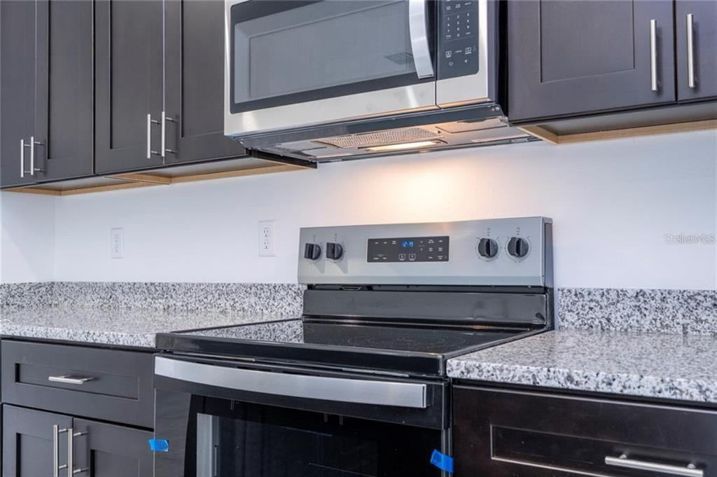 9809 North Swanee Terrace Citrus Springs, FL 34433 - Photo 14 of 46 a stove top oven sitting inside of a kitchen