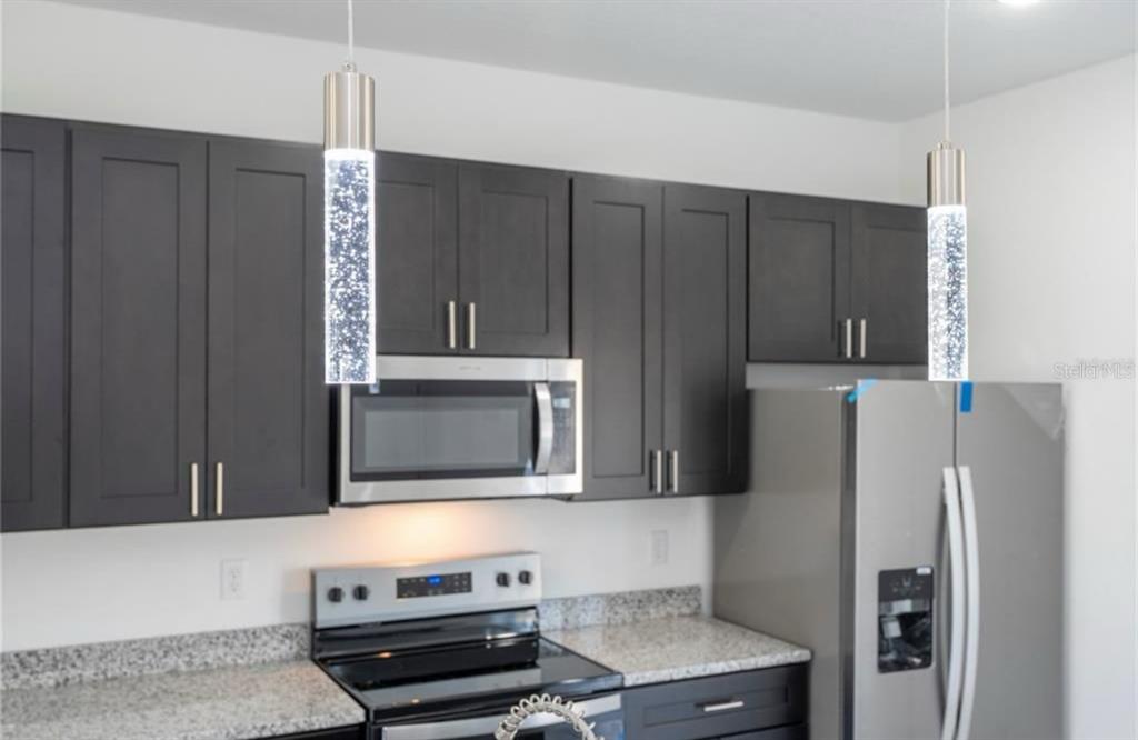 9809 North Swanee Terrace Citrus Springs, FL 34433 - Photo 16 of 46 a kitchen with stainless steel appliances granite countertop a refrigerator and a stove