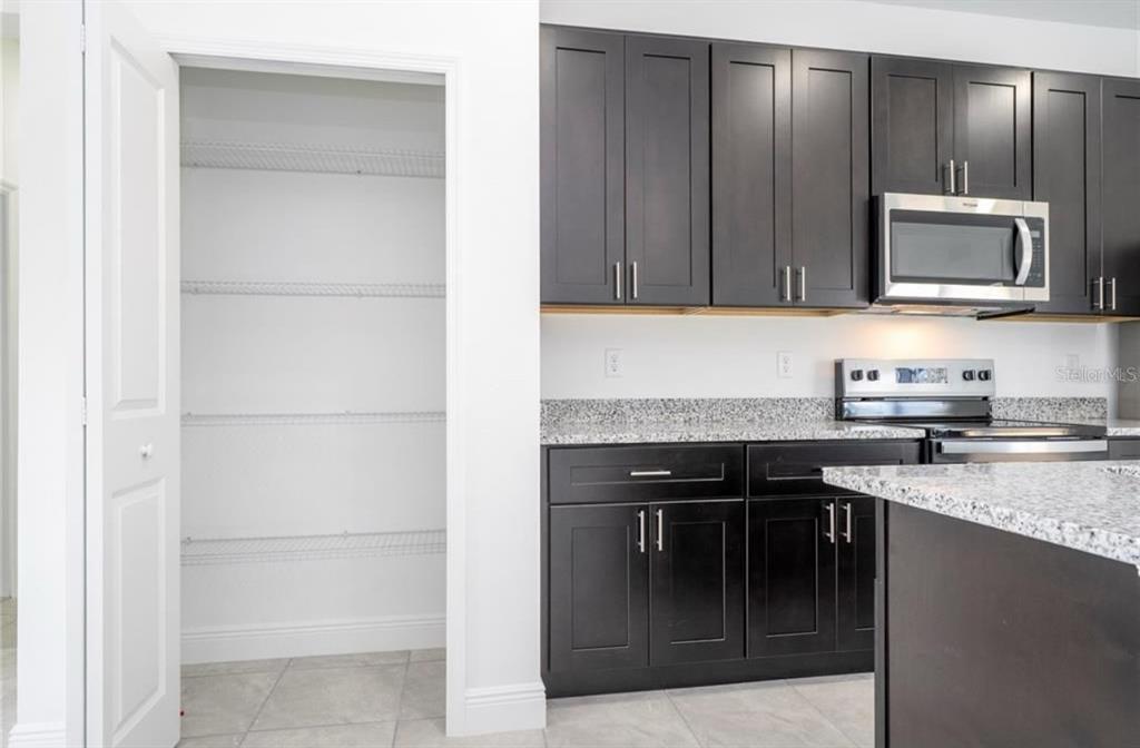 9809 North Swanee Terrace Citrus Springs, FL 34433 - Photo 17 of 46 a kitchen with a sink and a microwave