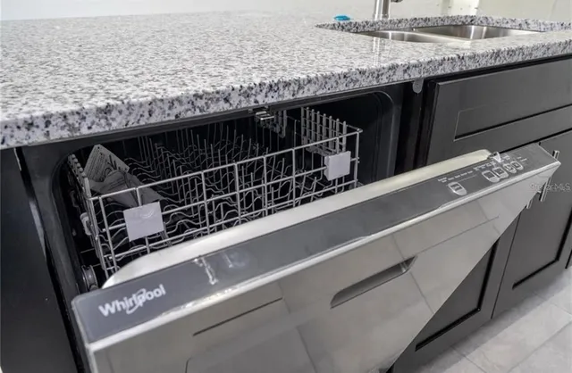 a kitchen with granite countertop a sink and a stove
