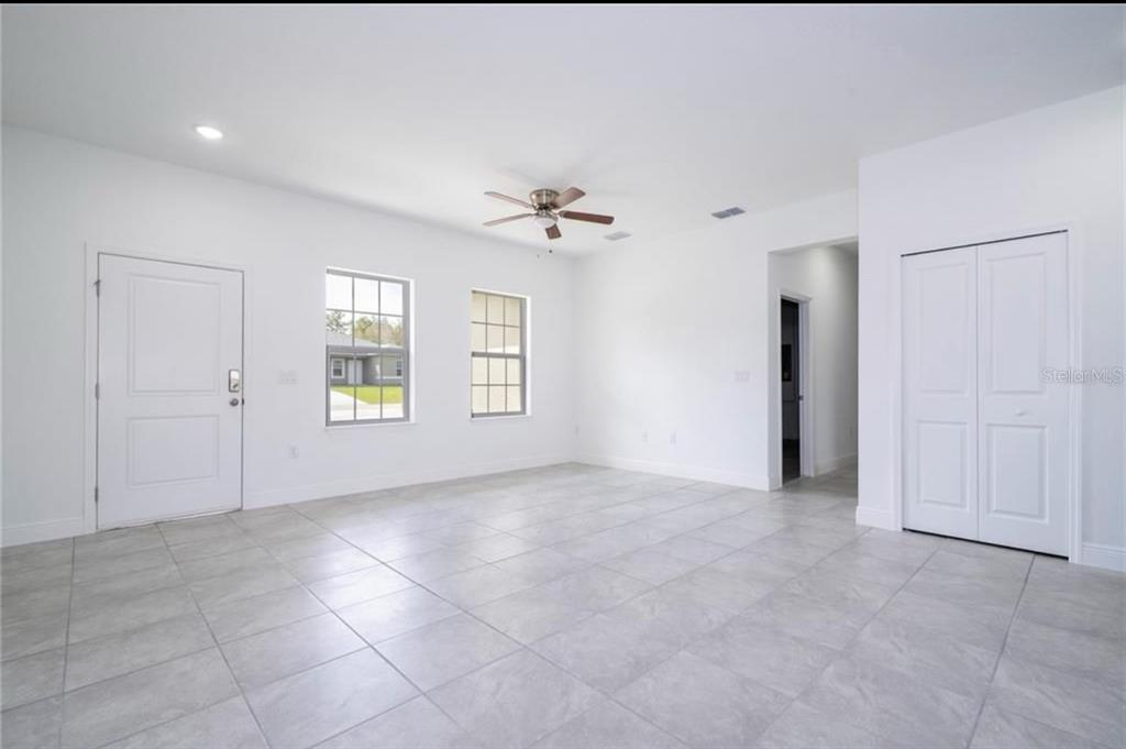 9809 North Swanee Terrace Citrus Springs, FL 34433 - Photo 21 of 46 an empty room with windows and ceiling fan