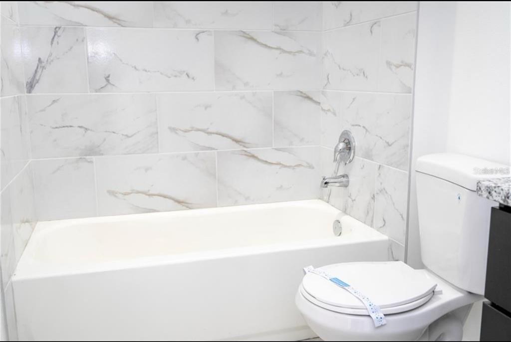 9809 North Swanee Terrace Citrus Springs, FL 34433 - Photo 37 of 46 a bathroom with a toilet and a bathtub