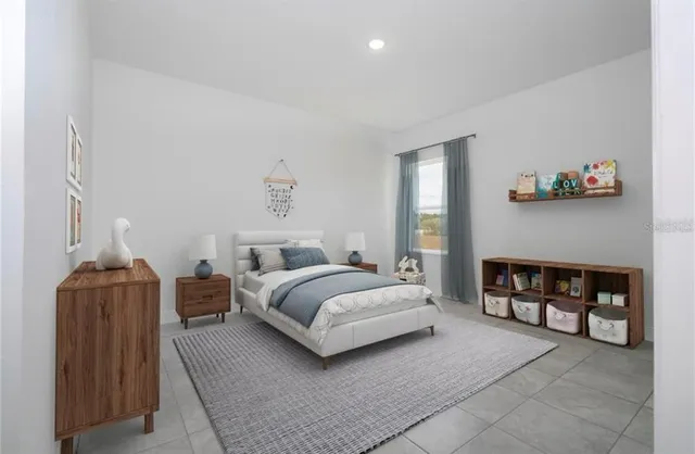 a spacious bedroom with a bed and a couch