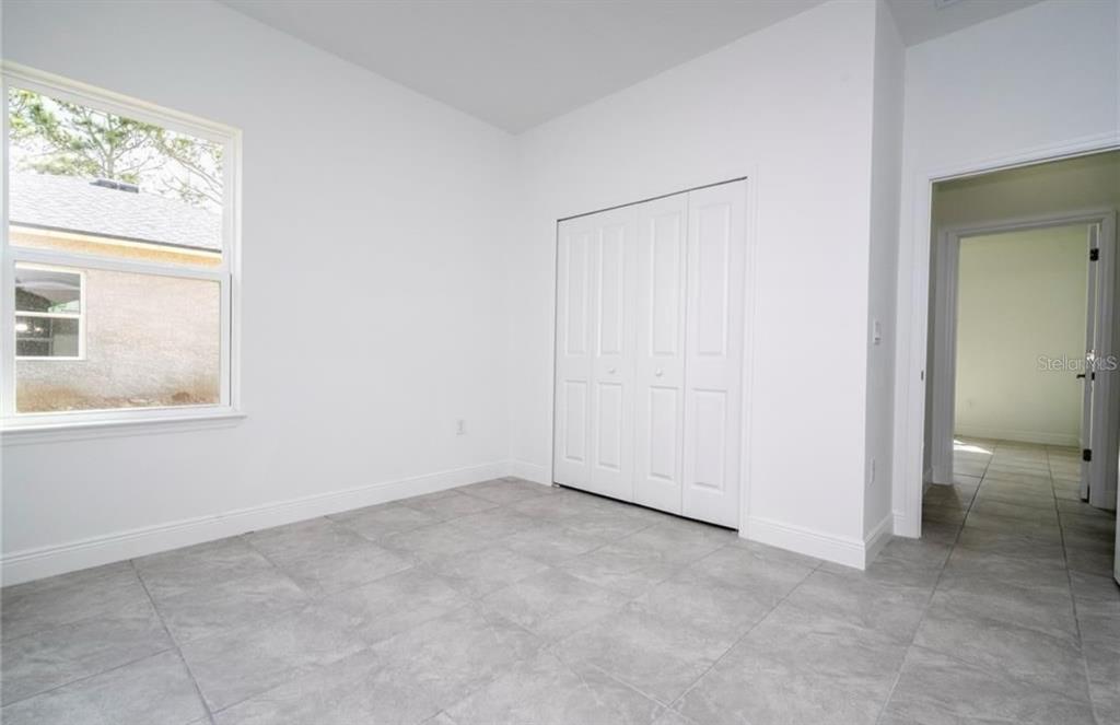 9809 North Swanee Terrace Citrus Springs, FL 34433 - Photo 44 of 46 an empty room with windows and closet