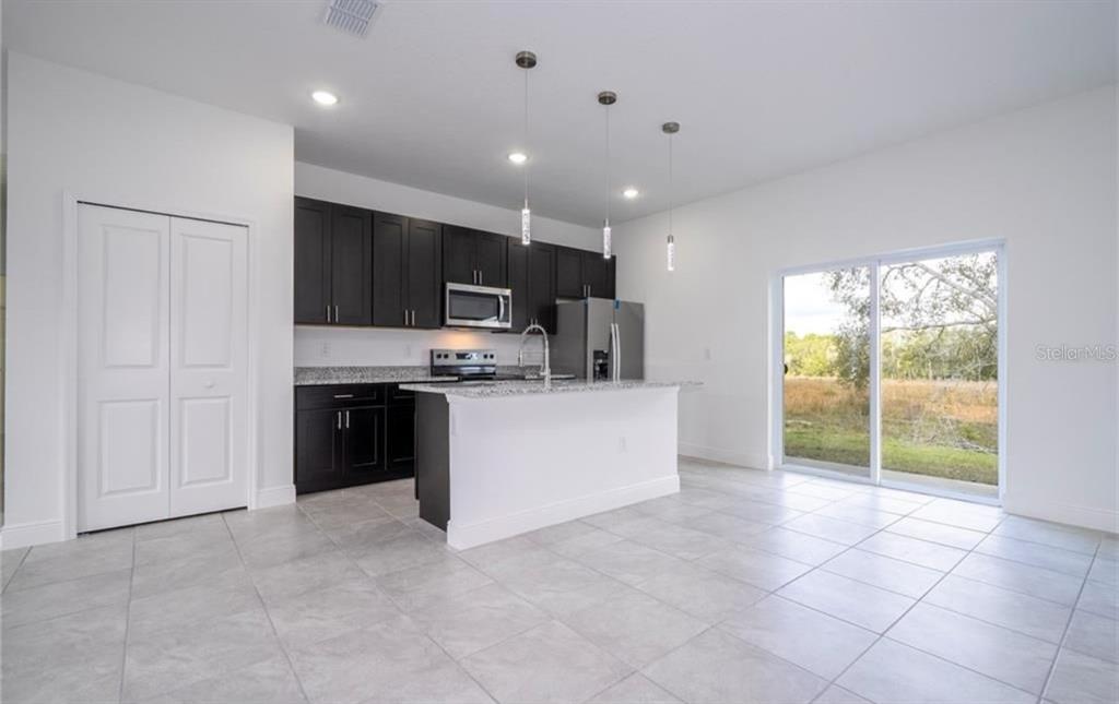 9809 North Swanee Terrace Citrus Springs, FL 34433 - Photo 10 of 46 a kitchen with stainless steel appliances a refrigerator sink and microwave