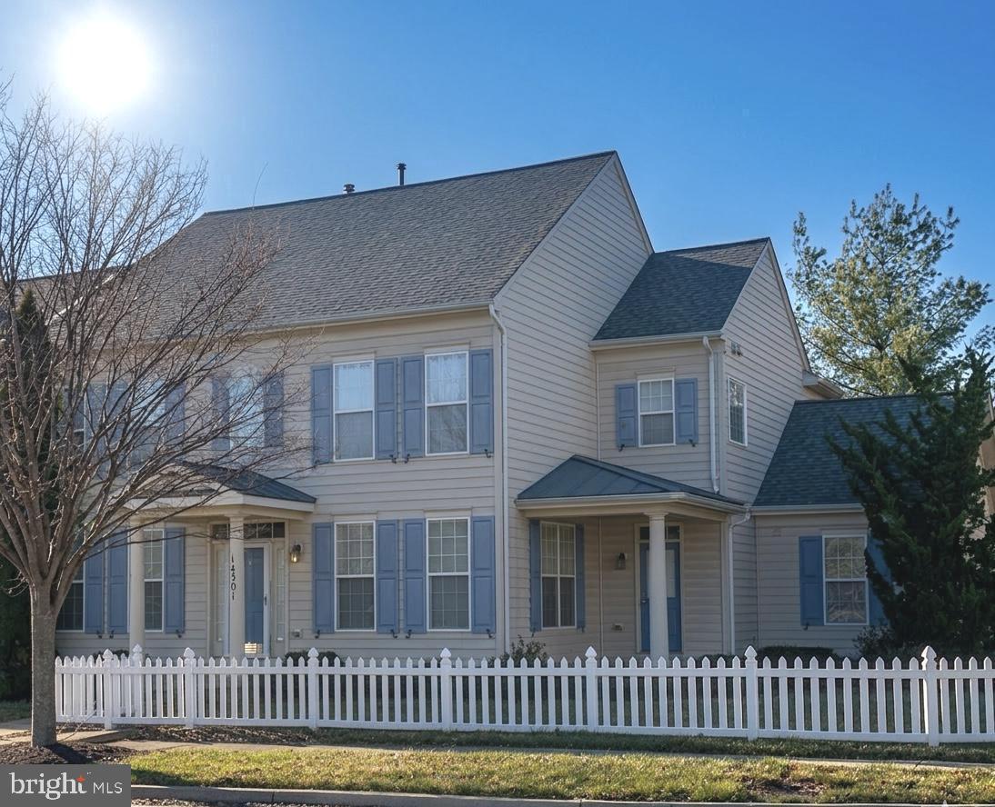 a front view of a house with a fence