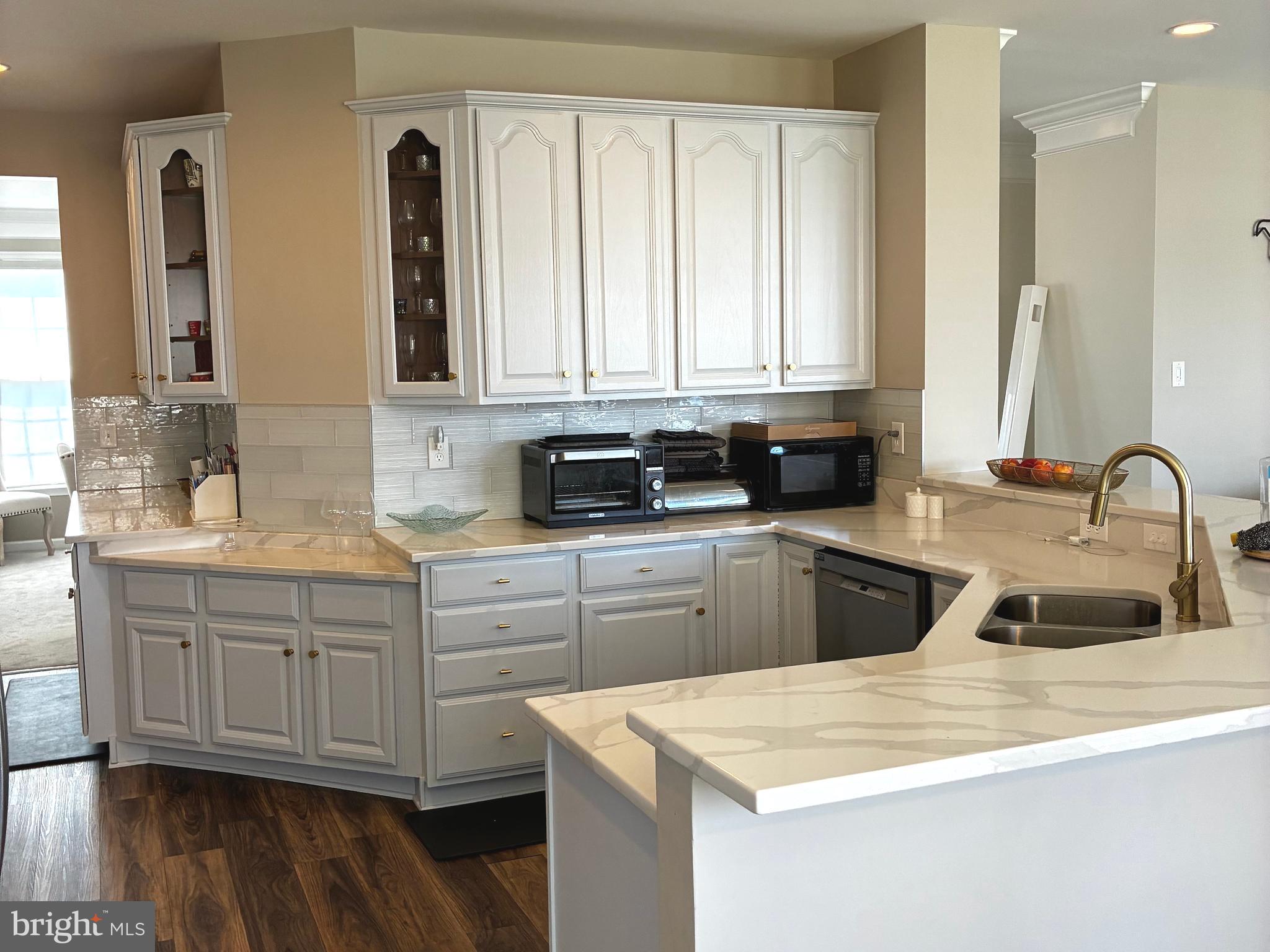 14301 Lightfoot Street Accokeek, MD 20607 - Photo 11 of 32 a kitchen with stainless steel appliances granite countertop a sink a stove and cabinets