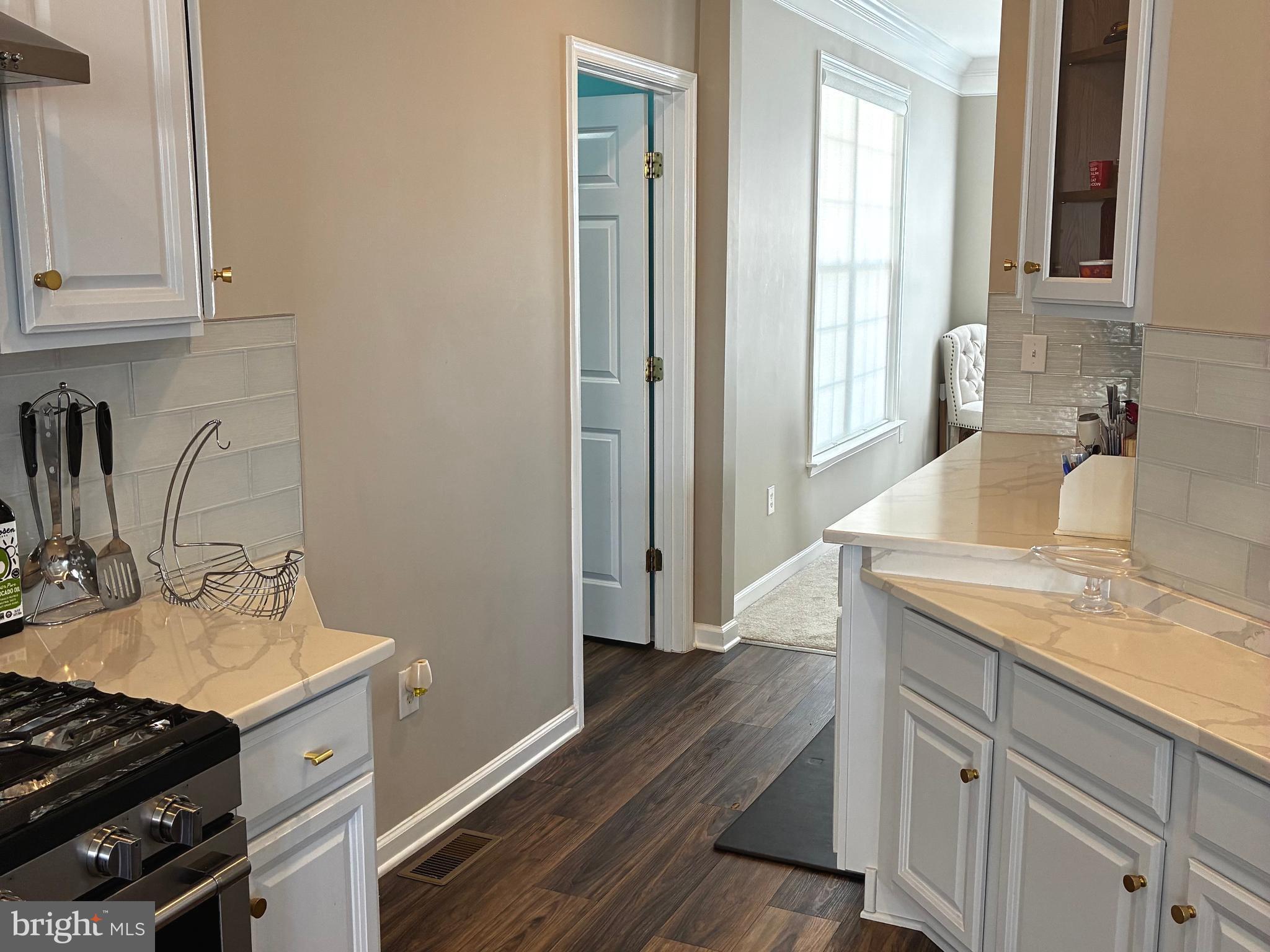 14301 Lightfoot Street Accokeek, MD 20607 - Photo 12 of 32 a kitchen with a sink stove and cabinets