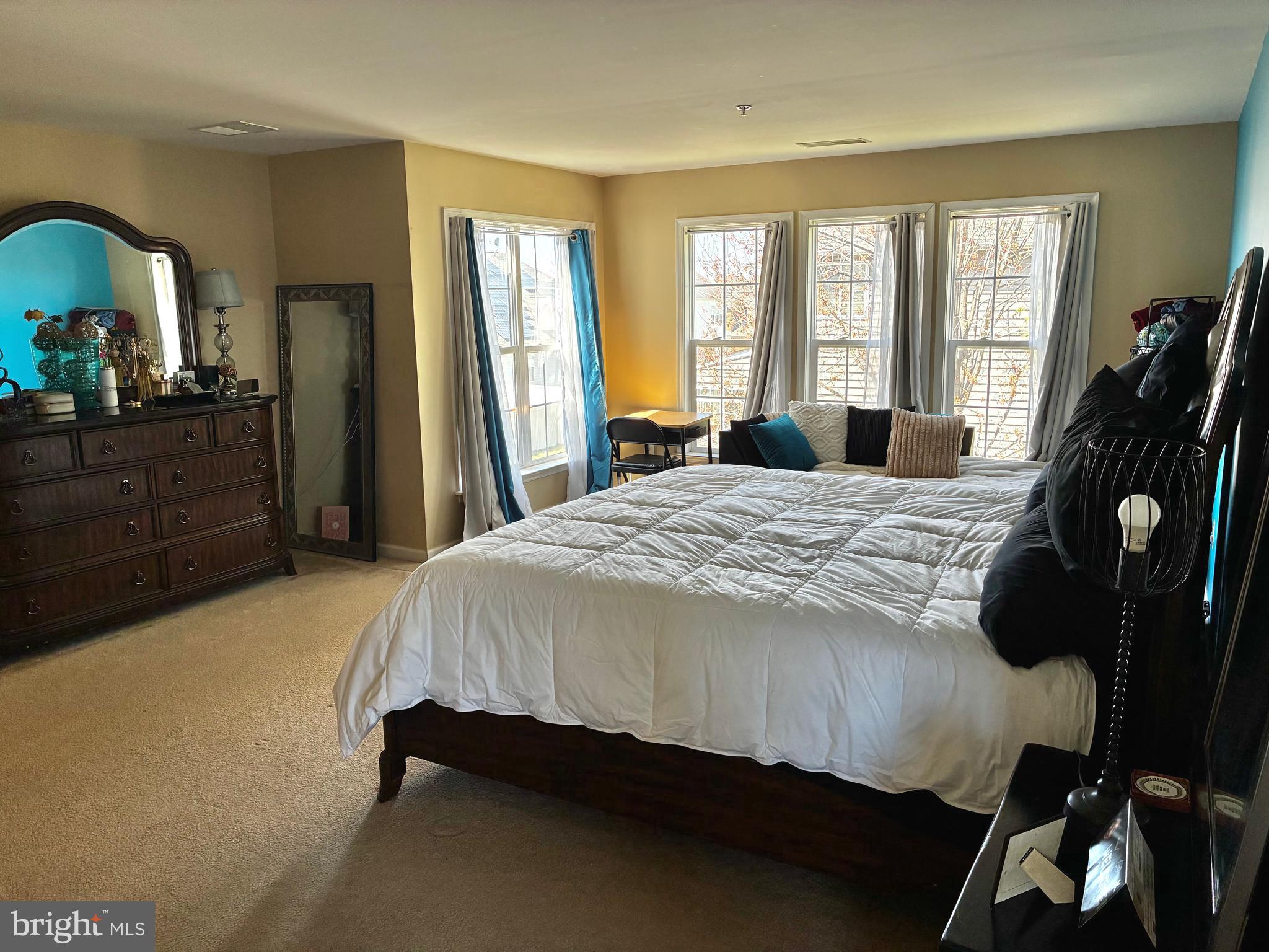 14301 Lightfoot Street Accokeek, MD 20607 - Photo 16 of 32 a bed sitting in a bedroom next to a window