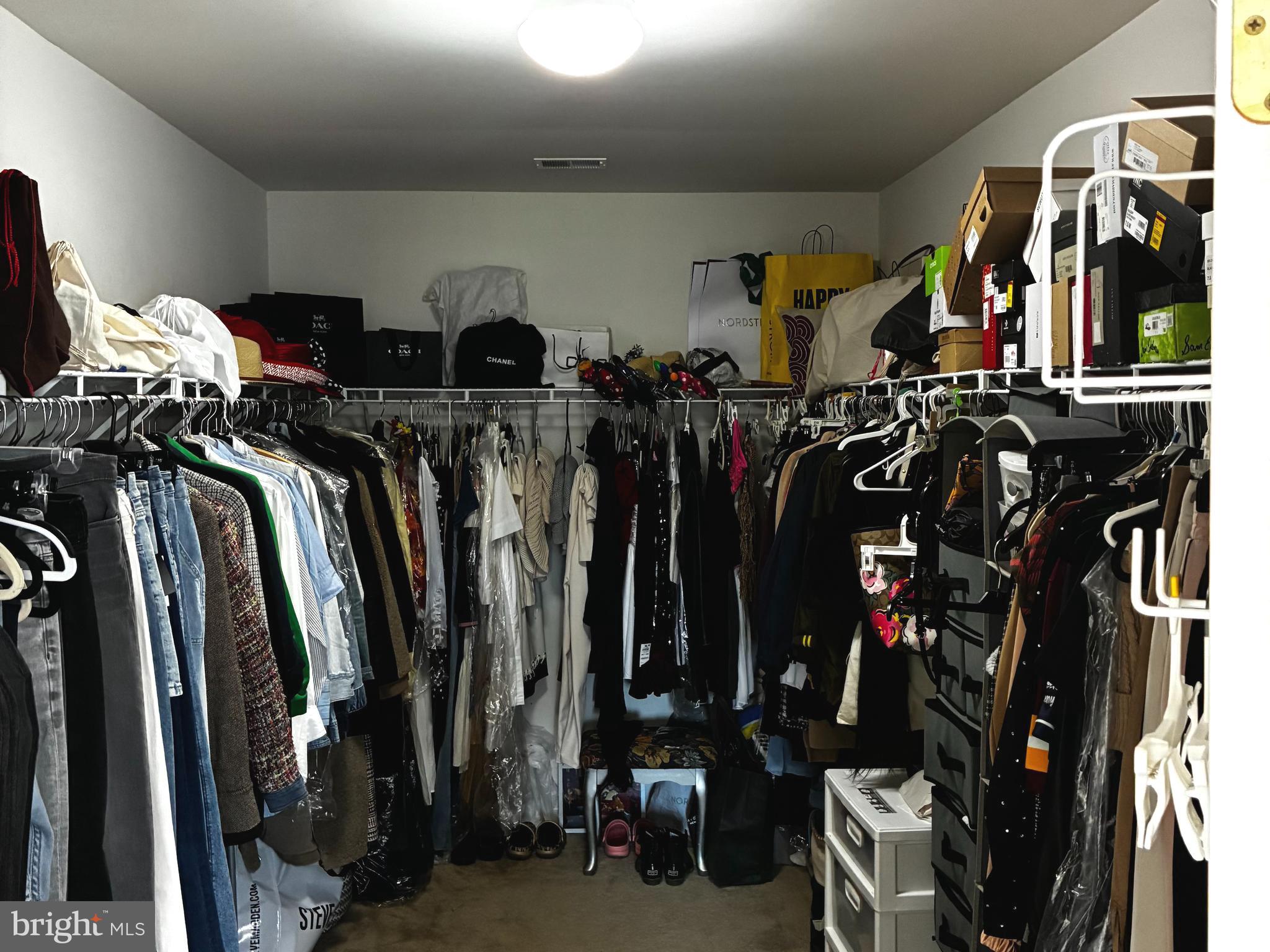14301 Lightfoot Street Accokeek, MD 20607 - Photo 18 of 32 a view of walk in closet with clothes
