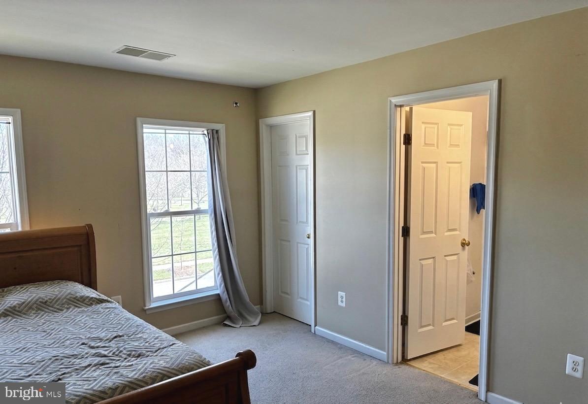 14301 Lightfoot Street Accokeek, MD 20607 - Photo 20 of 32 a bedroom with a bed and a window