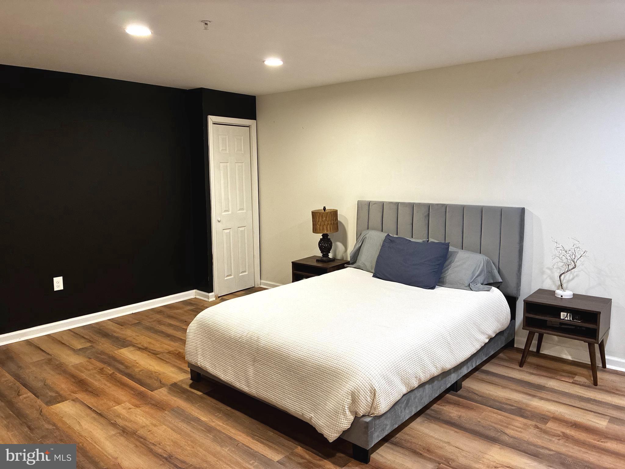 14301 Lightfoot Street Accokeek, MD 20607 - Photo 23 of 32 a bedroom with a bed and a night stand