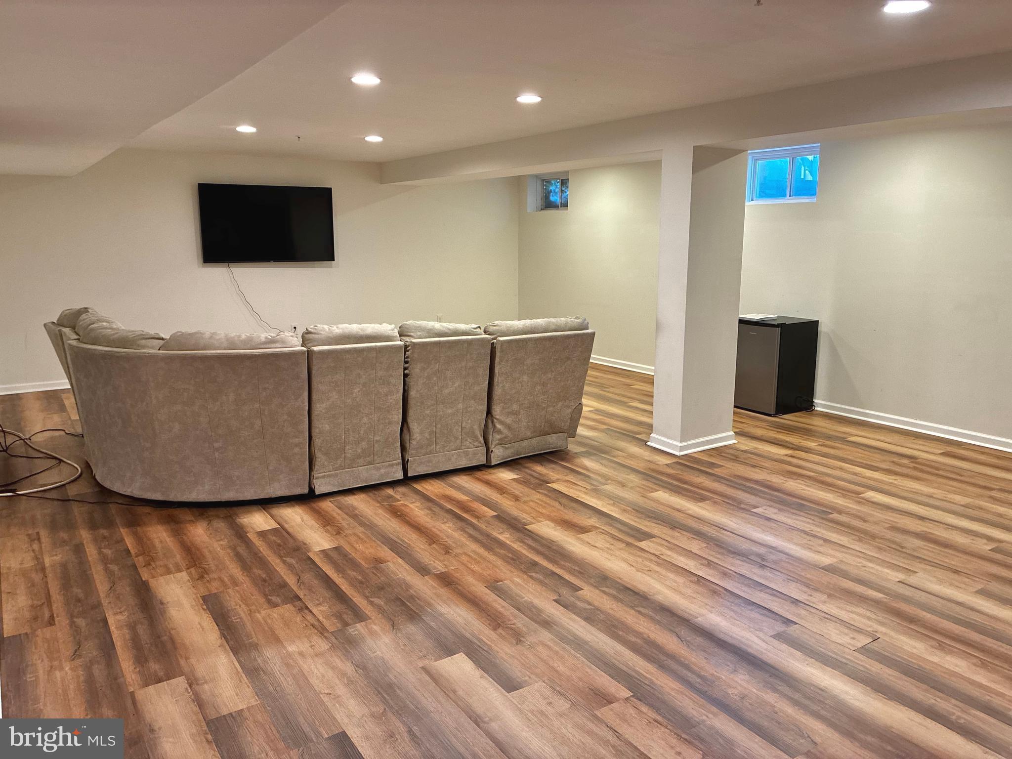 14301 Lightfoot Street Accokeek, MD 20607 - Photo 27 of 32 a living room with couch and a flat screen tv